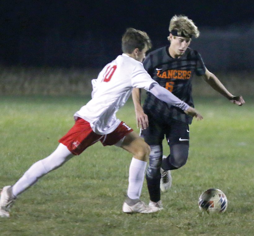 Lincolnwood&rsquo;s Mason Stauder (#6) keeps Vandalia&rsquo;s Issac Sachan from advancing the ball past midfield during the Lancers&rsquo; regional semifinal game on Tuesday, Oct. 11, at Terry Todt Field in Raymond. Stauder and company held the Vandals scoreless in a 6-0 decision that earned Lincolnwood a shot at their first regional title since 2016.