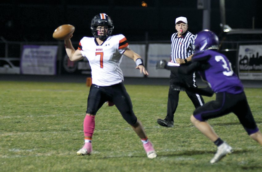 Zane Duff looks for an open receiver as Litchfield's Caiden Lamb bears down on the Hillsboro quarterback during the week nine clash between the two rivals on Oct. 21, in Litchfield. Duff ran for 100 yards and passed for 72 more in the Toppers' 48-36 come-from-behind victory over the Purple Panthers.