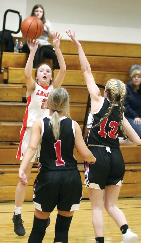 Lincolnwood&rsquo;s Haelee Damm pops a three over Bunker Hill&rsquo;s Taytem Brooks (#1) and Julianna Scroggins (#13) during the Lancers 41-21 win over the Minutemaids on Monday, Nov. 14. The Lancers have 11 threes in their first two games, with six against Bunker Hill and five in a 45-35 loss to Illini Central on Nov. 15.