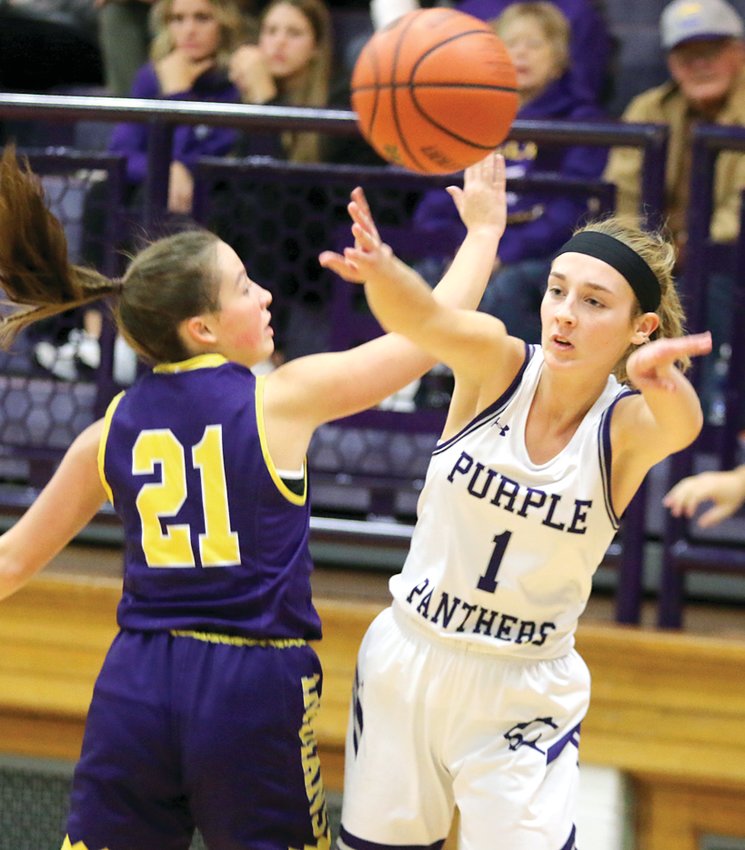 Litchfield's Hailey Rentz skirts Carlyle defender Raelyn Harris to find an open teammate during the Panthers' opening game of the Litchfield Thanksgiving Tournament. Carlyle's tenacious defense held Litchfield to just 15 points as the defending champions won 56-15 over the home team.