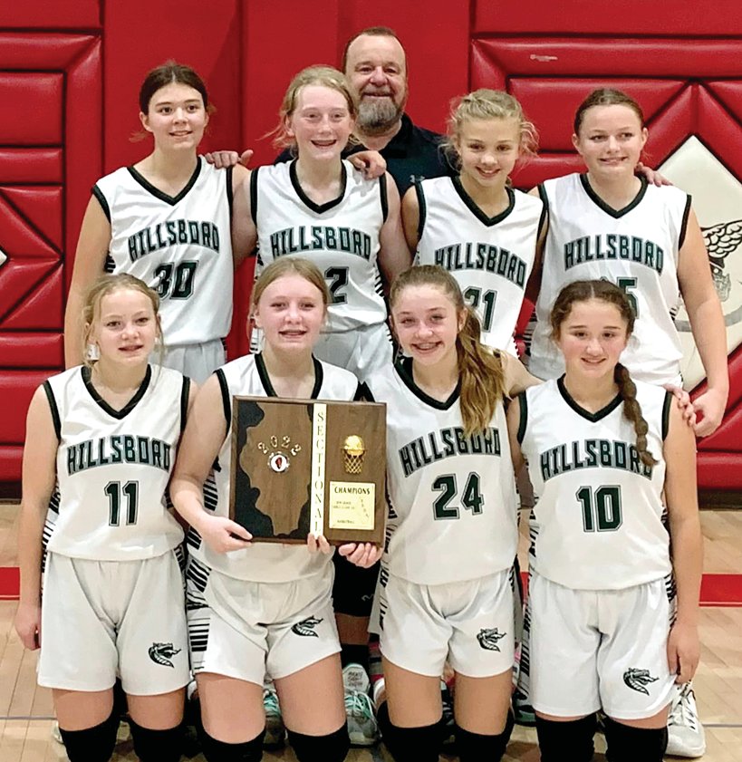 Three days after defeating Staunton 35-17 in the sectional final in Vandalia, the Hillsboro Lady Dragons found themselves just one win away from an IESA state championship. Pictured with their sectional title, in front, from the left are Mikenna McSperritt, Karsyn Greenwood, Amya Greenwood and Peyton Christian. In the back are Kendall Peterson, Delaney Adams, Peyton Chappelear and Albany Kindernay, with Coach Kenny White.