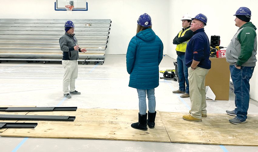 Litchfield Superintendent Dr. Greggory Fuerstenau, at left, gives the board an update in the gym at the new State Street elementary school project as part of the regular board meeting on Tuesday evening, Dec. 20.