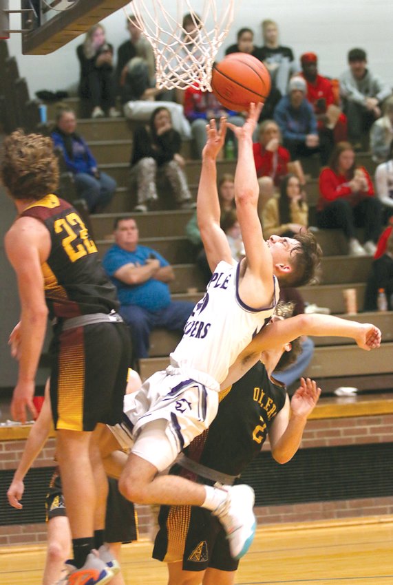 Litchfield's Gavin Thimsen is sandwiched in between East Alton-Wood River's Seth Slayden (#22) and Jakob Gerber (#4) while going up for a shot in the championship game of the Carlinville Holiday Tournament on Thursday, Dec. 29. Thimsen scored four points in Litchfield's 62-54 win over the Oilers that gave the Panthers' their first championship at Carlinville in 10 years.