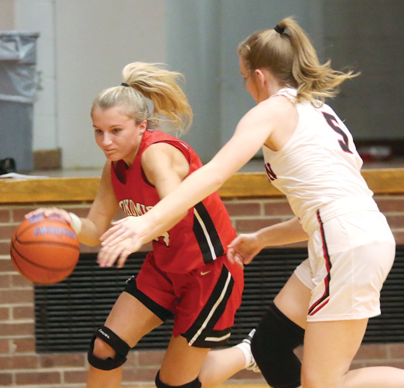 Nokomis guard Addison Dangbar (left) drives by Calhoun defender Gracie Klaas during the championship game of the Carlinville Holiday Tournament on Thursday, Dec. 29. Dangbar had a team-high 11 points in the Redskins' 41-34 loss to the Warriors and was named to this year's all-tournament team.