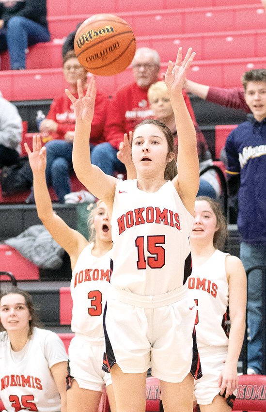 Nokomis freshman Camryn Engelman (#15) hits a three during the Lady Redskins' 57-22 win over South Fork on Monday, Jan. 9, much to the delight of her sister Natalie (#5) and cousin Hailey (#3). The win put Nokomis alone at the top of the MSM Conference standings with a 5-0 record and two conference games to play.