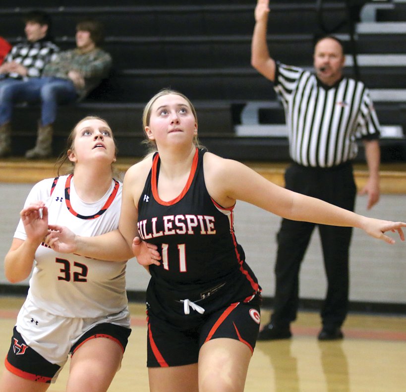 Gillespie's Jenna Clark (#11) tries to box out Hillsboro's Sophia Blankenship (#32) during a free throw in the second half of the Toppers' home game on Thursday, Jan. 26. The Hiltoppers won the battle of the orange and black 71-39, thanks in part to a 36-12 first quarter advantage.