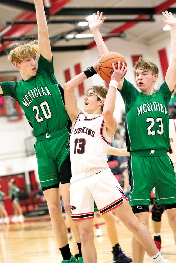 Nokomis' 5'8&quot; Mason Stauder goes in amongst the trees, Meridian's 6'4&quot; Brett Brown and 6'5&quot; Brooks Brown, during the Redskins' home game on Friday, Jan. 27. Stauder had six points off the bench for Nokomis, who improved to 21-5 with a 55-41 win over the Hawks.