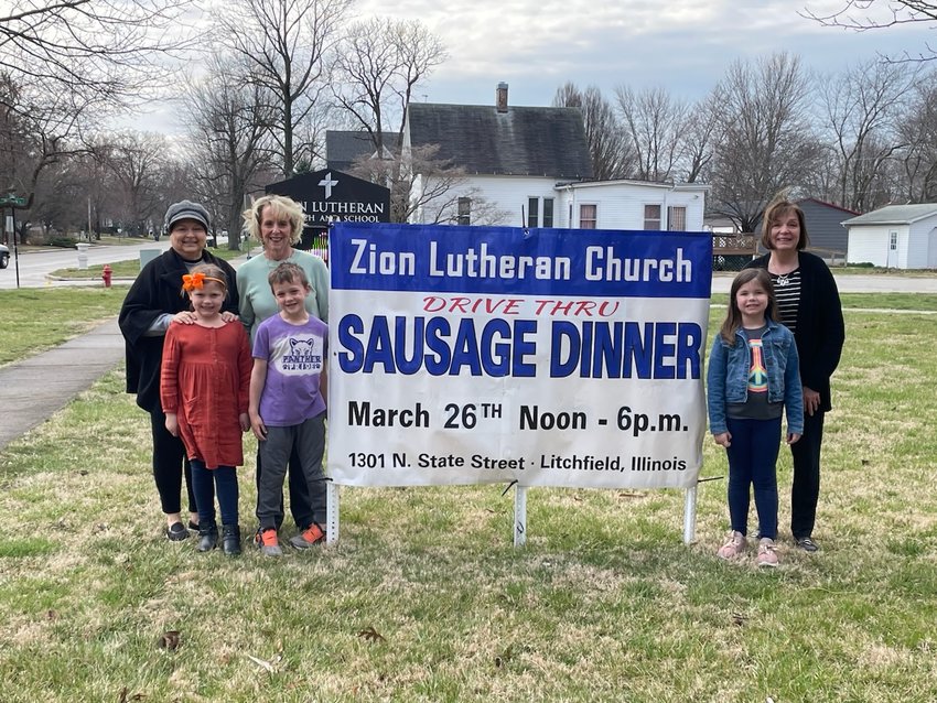 Volunteers are ready for the annual Zion Lutheran Church drive-through sausage dinner this weekend. From the left are Jan Meyers with her granddaughter Camryn Dambacher, Nancy Hyam with her grandson, Bennett Hyam, and Becky Helgen with her granddaughter, Caroline Helgen.