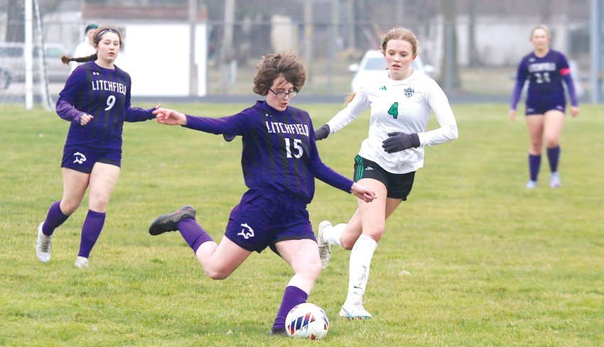 Litchfield's Alex Rhodes clears a ball away from Athens forward Karsyn Jacoby during the first half of the Panthers' home game against the Warriors on Thursday, March 23. Rhodes, Avery Stewart (#9) and the Litchfield defense did a good job limiting Athens' access to the goal, but a goal from Katie Kuehl, assisted by Jacoby, stood up for a 1-0 win by the Warriors.