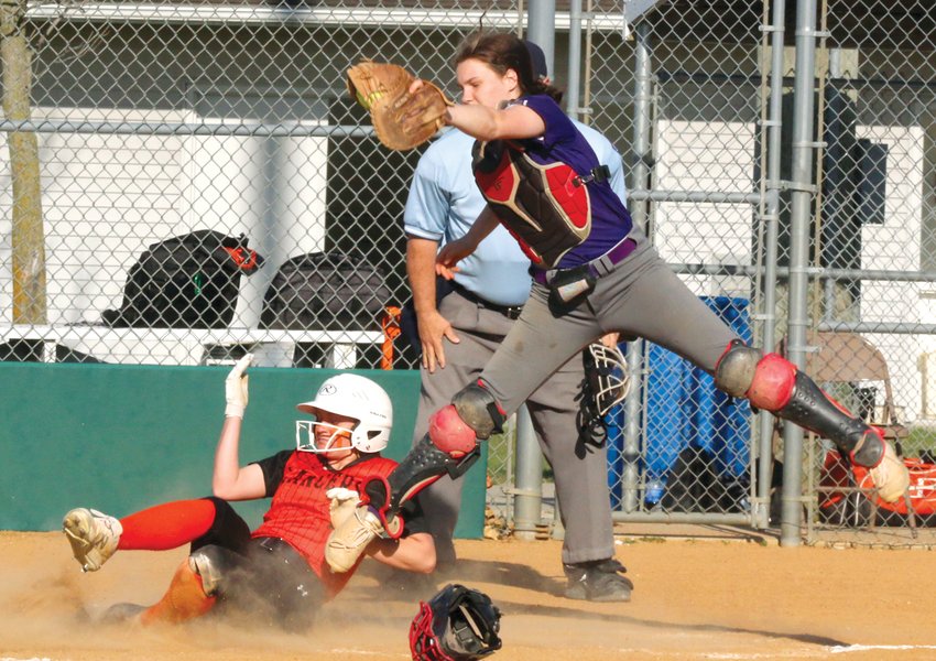 Lincolnwood&rsquo;s Taryn Clarke slides safely in to home plate as a high throw pulls Litchfield catcher Bella Roach off the bag. Clarke scored twice in the Lancers come-from-behind 12-11 victory over Litchfield on Monday, April 10.