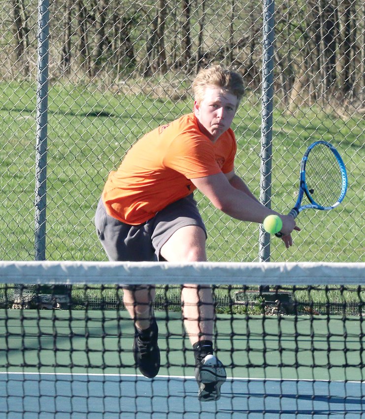 Hillsboro senior Kyle Butler lunges for a shot during his number one match with Greenville at the Hillsboro Sports Complex on Tuesday, April 11. The Toppers will be back at home on Thursday, April 13, to face Metro-East Lutheran.