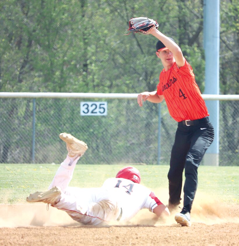 Nokomis' Ryan Eisenbarth dives back into second base in an effort to beat the throw to Lincolnwood's Jared Klein during the Montgomery County Tournament game on Saturday, April 15, in Hillsboro. Eisenbarth had two hits for the Redskins, who beat Lincolnwood 4-1 in their first game of the tourney.