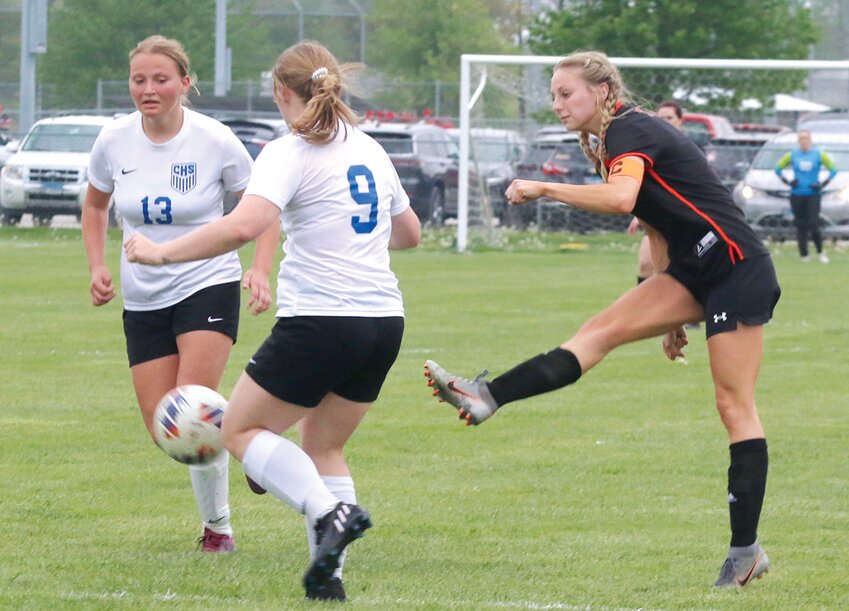 Hillsboro's Sierra Compton puts a shot between Carlinville's Sophia Campbell (#13) and Lana Vanderpoel (#9) late in the second half of the South Central Conference showdown on Thursday, April 27. Compton was one of six seniors honored by the Lady Hiltoppers prior to the game, which Hillsboro won by a 3-2 final score.