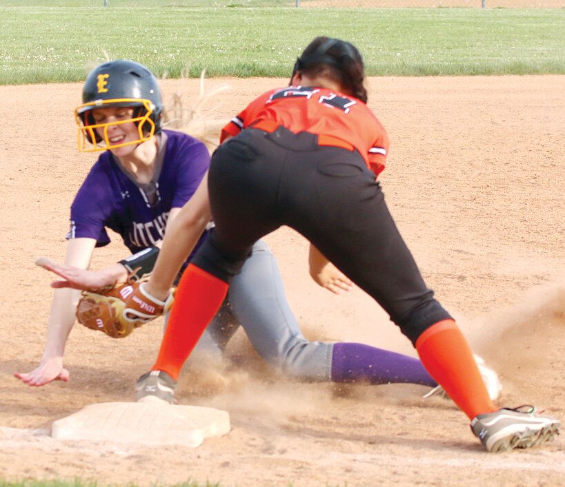 Litchfield's Annika Rhodes slides into third base and Hillsboro third baseman Mackenzie Jarman during the match-up between the two rivals in Hillsboro on April 28. Rhodes was safe on the play after the ball was jarred loose from Jarman's glove and Litchfield went on to win 5-2.