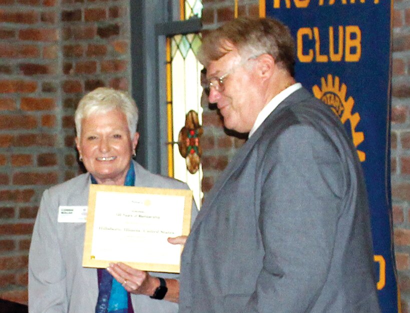 Above, Rotary District #6490 Governor Connie Walsh presents  a certificate to Hillsboro Rotary President Stephen Cullison, honoring the chapters 100 years of service.