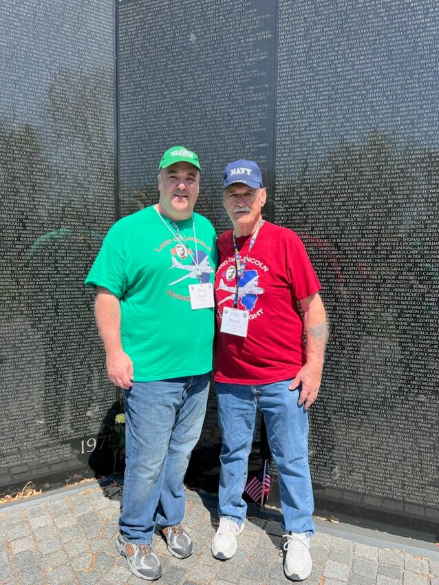 U.S. Navy veteran Felix Powell of Hillsboro, at right, stops to view the Vietnam Veterans Memorial in Washington, D.C. with his son and guardian, David Powell of Hillsboro, at left, during the Honor Flight trip.