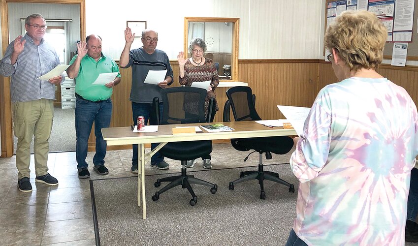 Schram City Village Clerk Janet Stewart (front) administered the oath of office to trustees (from the left) Earl Eller, Bill Clinard, Kevin Tuetken and Pat Rhoades during the board meeting on Monday, May 8.