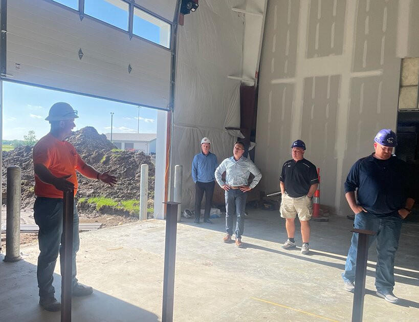 Eric Kohnen of Poettker Construction, at left, shows the board progress on the South Central Illinois Regional Training and Innovation Center before their regular meeting on Tuesday evening, May 16. Above, he shows the newly installed roll-up doors in the welding room.