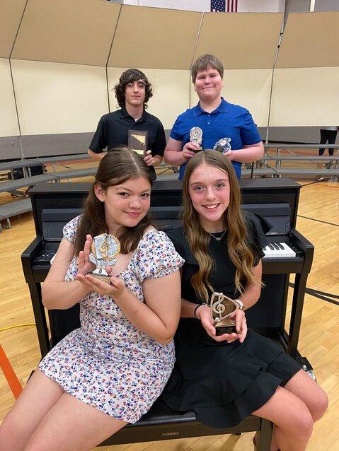 Award recipients, in front, from the left are Mally Robinson and Kamdyn Putnam. In back are Owen Earnest and Will Netemeyer.