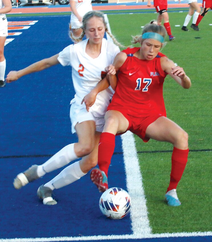 Bailey Leach of Pleasant Plains (#17) tries to shield Hillsboro's Sierra Compton from the ball during the first half of the sectional semifinal game in Riverton on Tuesday, May 16. Leach had one of the Cardinals' six goals in their 6-0 win over the Hiltoppers that moved them on to face Sacred Heart-Griffin in Friday's championship game.