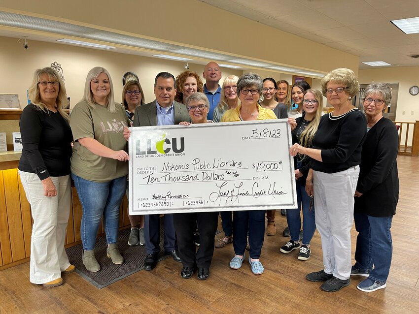 Land of Lincoln Credit Union presented a generous donation to help with renovations to Nokomis Public Library on Monday, May 8. From the left, are Brenda Hill (NSB loan processor), Lucy Slightom (LLCU branch manager), Lisa Billingsley (library trustee), Robert Ares (LLCU president and CEO), Lisa Casterline (library director-in-training), Cynthia Crowe (library trustee), Charles O&rsquo;Malley (NSB president and CEO), Debra Lehman (library director), Chris Ukena (library trustee), Lacey Saunders (NSB teller), Kathy Marinangel (NSB advisor), Kaelynn Carlock (NSB teller), Allison Maretti (library trustee), Judy Ruppert (library trustee) and Brenda Matthews (library trustee).