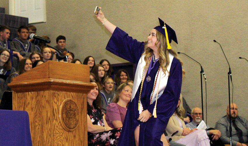 Above Class Speaker Laura Boston takes a quick selfie with her classmates during her commencement address.