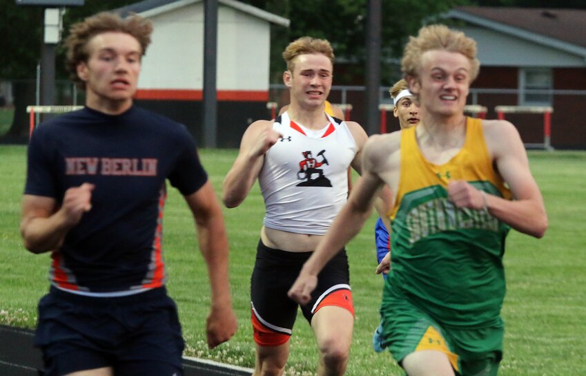 Hillsboro's Dylan Lessman (center) sprints toward the finish line in the 200 meter dash at the Gillespie Sectional on Thursday, May 18. Lessman finished 10th in the 200, but also scored points for the Toppers in the 100, where he finished sixth, and 400, where he finished third.