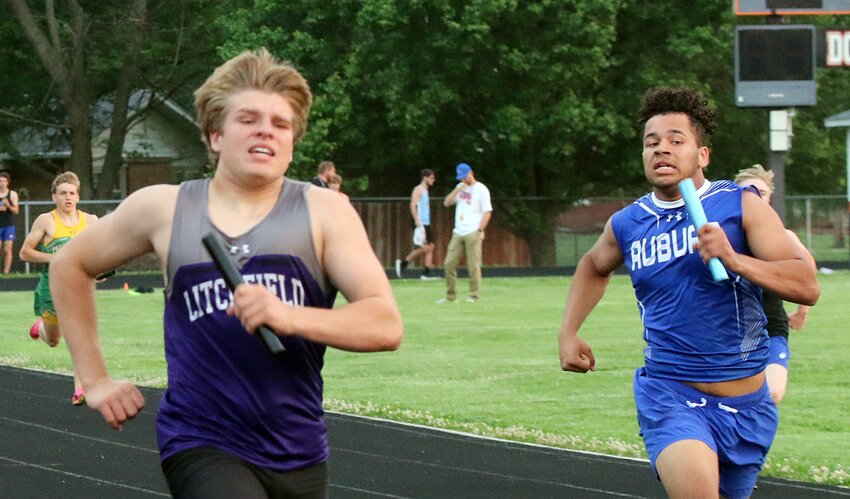 Litchfield's Kaden Bergman and Auburn's Treshaun Lancaster sprint to the next handoff of the 4x200 relay at the IHSA Class 1A sectional in Gillespie on Thursday, May 18. Bergman and teammates Martavious Jones, Zach Leitschuh and Easton Grammer finished fifth overall in a time of 1:38.49.