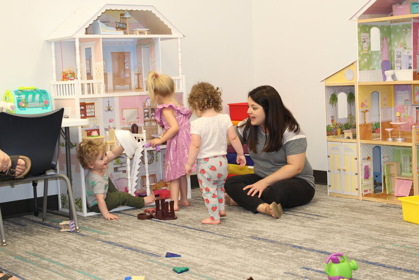 Above, the tiny tots enrolled in the Montgomery County Learning Express program enjoy a little free play during May&rsquo;s Library Lapsit program.