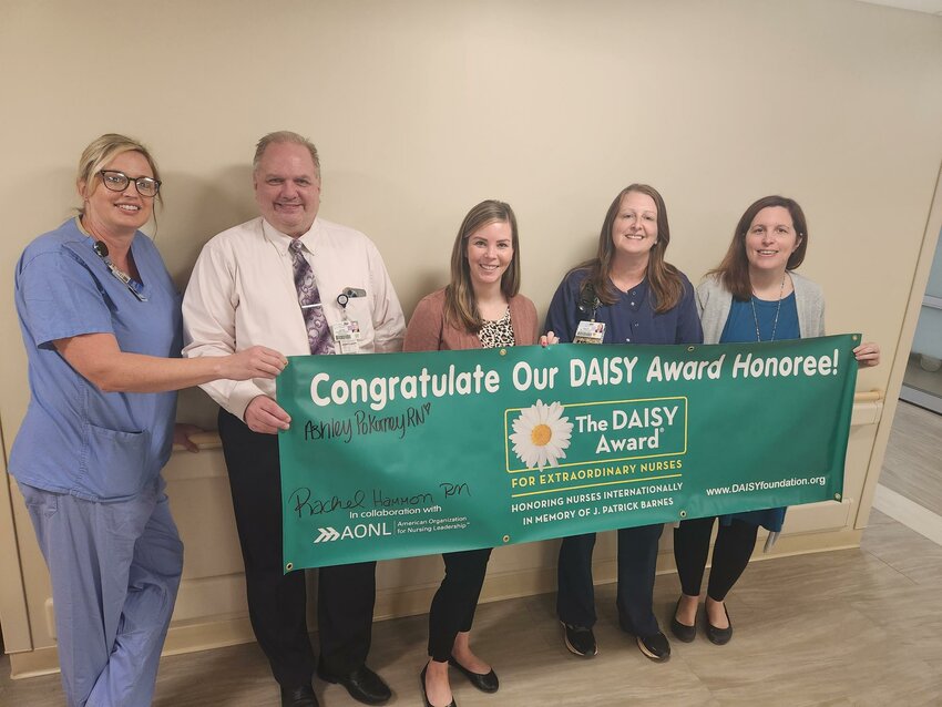 Rachel Hammon, emergency department RN, (fourth from left), was recently named St. Francis Hospital&rsquo;s DAISY Award winner. Hammon was congratulated by (left to right) Karen Webb, emergency department Manager, Jim Timpe, CEO, Heather Senaldi, director of nursing and Bethany Price, RN educator.