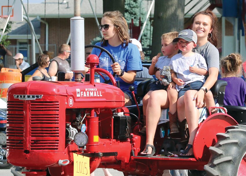 Members of the Hart family took home first and third place honors for their entries in the Antique Tractor category of the parade. Pictured above, from the left are Carley Hart, Stockton, Weston and Alexis Brown.