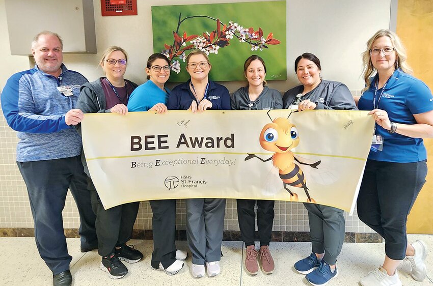 HSHS St. Francis Hospital colleagues on hand to congratulate Cassie James, Radiology, who was named the BEE Award winner, were (left to right) Jim Timpe, CEO; Jennifer Lewis Radiology Manager, Carrie Small, Radiology; Lauren Armstrong, Radiology; Cassie James; Sam Moseley, Radiology, Aryn Hunter, Director of Operations.