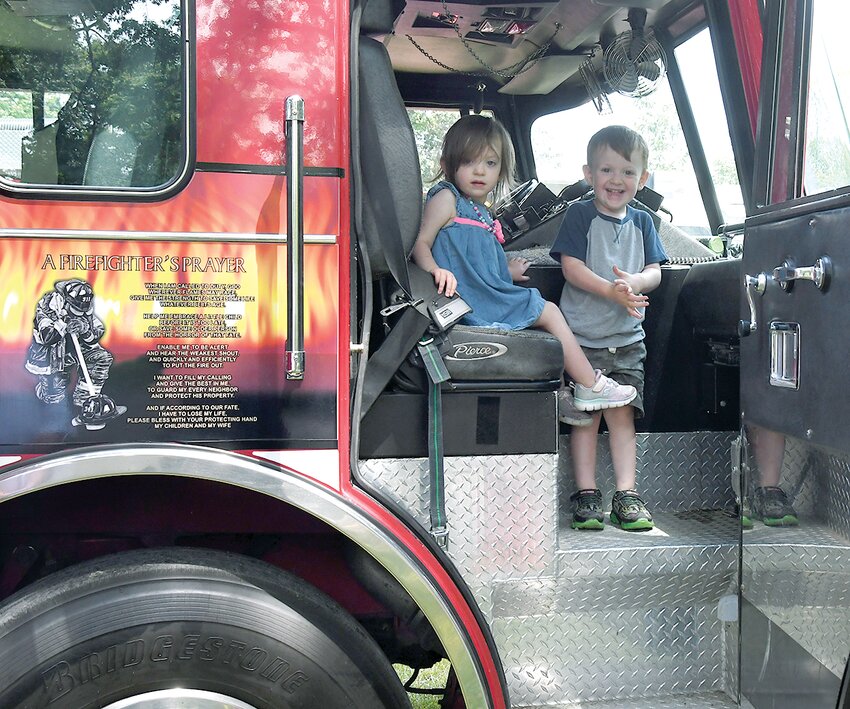 Mia and Elias Redman, grandchildren of Taylor Springs Fire Chief Brian Redman, take a look at the cab of the Taylor Springs fire truck during the First Responders Day on June 10.