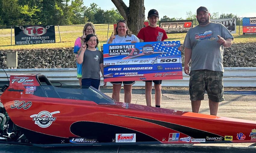 Timothy Hearn (second from the right) took his junior dragster to victory lane on June 4, as he won his class at the Midstate Lucky Sevens event at the Central Illinois Dragway in Havana. Pictured with Hearn are his younger brother Brayden, his parents Michelle and David and fellow junior dragster racer Rebekah Motley.