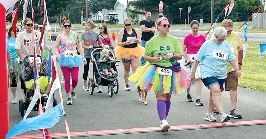 Run, walk or ride, nearly 50 eager individuals crossed the starting line at the first Tutus and Bow Ties Fun Run to benefit Project Third Day-Panhandle on Saturday, June 10, in Raymond.