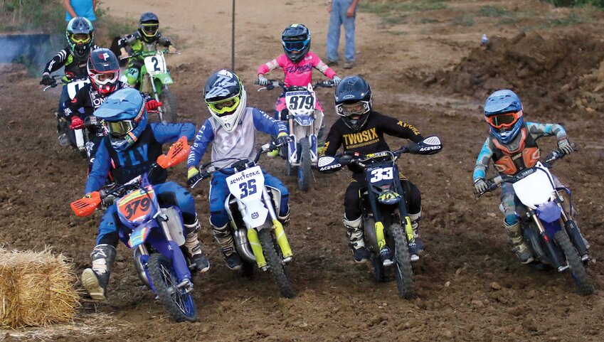 From the left, Hudson Wright, Ryder Armstrong, Colt Rosentreter and Cam Bone go four wide around the first turn in the 65cc class at the Montgomery County Fair motocross event on Friday, June 23. Armstrong finished first in the class, followed by Wright, Rosentreter and Bone.