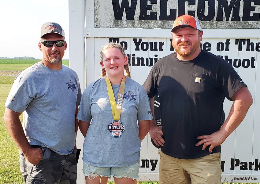 Litchfield Middle School student Allison Belusko, center, earned first place in the novice female division. She is pictured above with her coaches, Tom Melchert, at left, and Kyle &ldquo;Hootie&rdquo; Sutton.