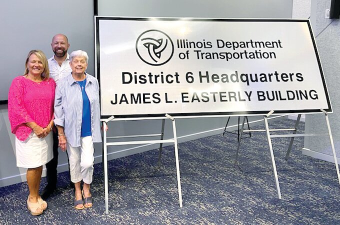 The  Illinois Department of Transportation dedicated its new headquarters in honor of the late James L. Easterly, a lifelong Litchfield resident who spent his entire career in a variety of roles in the department. Pictured above with the new sign for the building are Easterly&rsquo;s wife, Gale Easterly, daughter, Tammy Rahn, and son, Gregg Easterly.