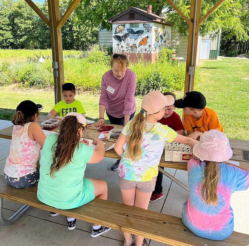 Hillsboro students enjoyed their visit to Bremer Sanctuary on June 21 as they learned about local bird species. Pictured above, Linda Meyers assists a group of students as they work on coloring pages.