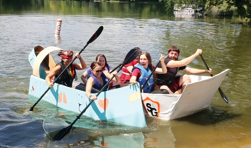 Saddle Gun, the only coardboard boat with a four-person crew, narrowly edged Boo Boo Boat in the closest finish in the Imagine Hillsboro Cardboard Boat Regatta Saturday, July 15, at Old Lake Hillsboro.  Boo Boo Boat later got its revenge and went on to finish second in the event.