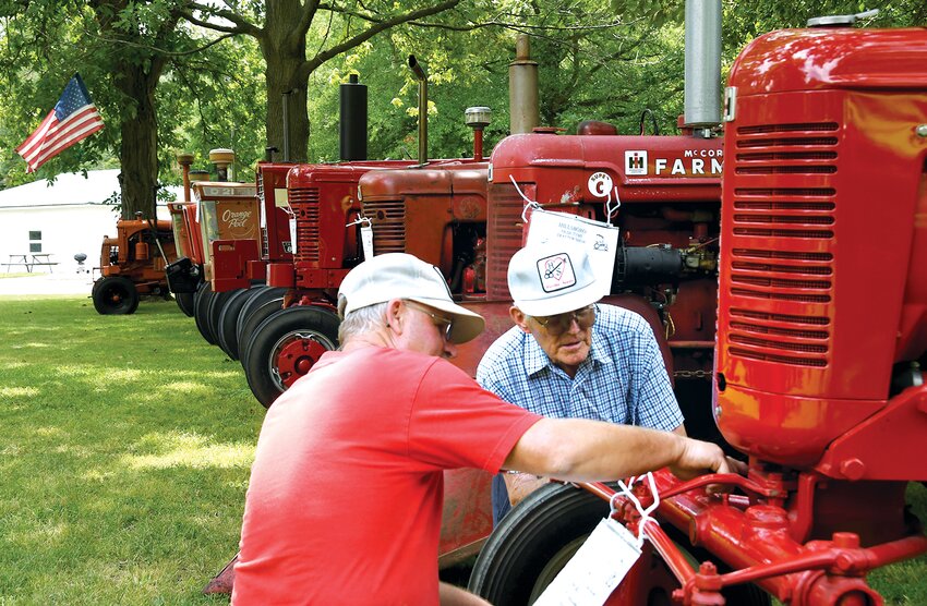 Nearly 90 tractors were on display this weekend for the annual Old Tyme Tractor Show, which returned to Lake Hillsboro Park July 15-16. The two-day event featured a variety of tractor and lawn and garden tractor games, a kids pedal tractor pull, kids&rsquo; pedal races, tractor train rides, food trucks and more. Pictured above, David and Maynard Hartke of Litchfield check out some of the Farmall tractors on display on Saturday afternoon.