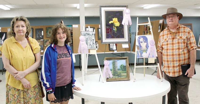 The Old Settlers Art Show officially opened on Wednesday afternoon, Aug. 9, in the basement of St. Paul&rsquo;s Lutheran Church in Hillsboro. From the left, are &ldquo;Best of Show&rdquo; winners Jo Hutson, Mette Lee and Marvin Thomas. Not pictured is Lilly Jeffers.
