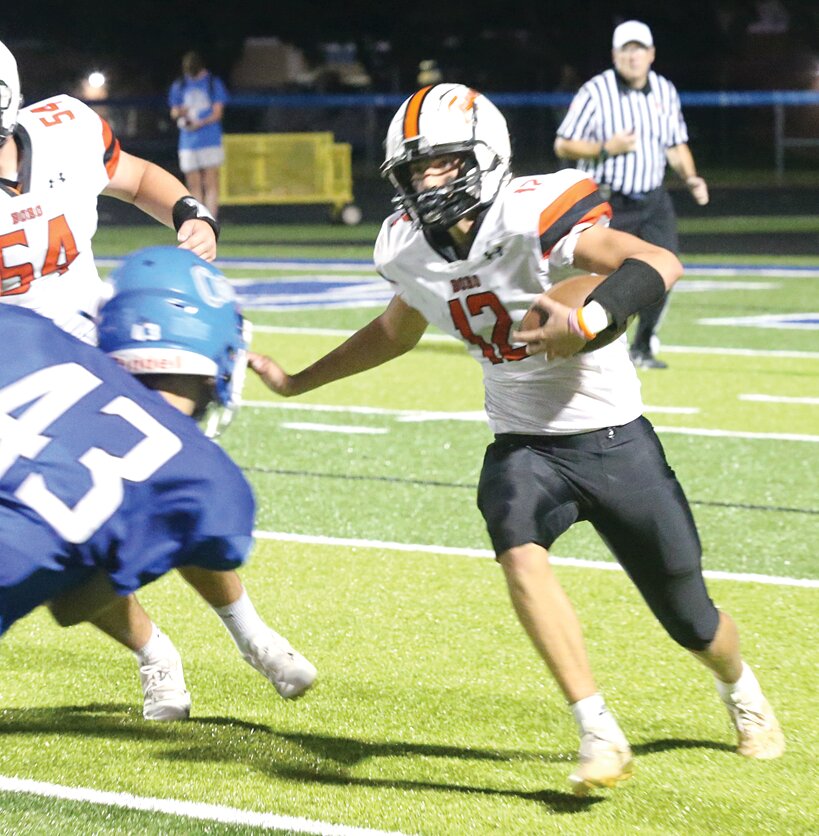 Hillsboro quarterback Jace Stewart ran elusively at Greenville on Friday, Sept. 1, but Comet defenders like Austin Wall (#43) made offense difficult for the Toppers in a 27-7 loss to the home team.