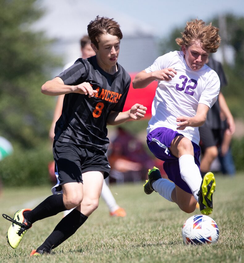 Taylorville&rsquo;s Lincoln Coffey (#32) tries to stay a step ahead of Lincolnwood&rsquo;s Charlie Clavin (#8, via Nokomis) during their game at Terry Todt Field in Raymond on Sept. 2. Behind five goals from junior Ian Keller, the Lancers improved to 5-1 on the season with an 8-0 victory over Taylorville. More photos from this game can be found at nokophoto.smugmug.com.