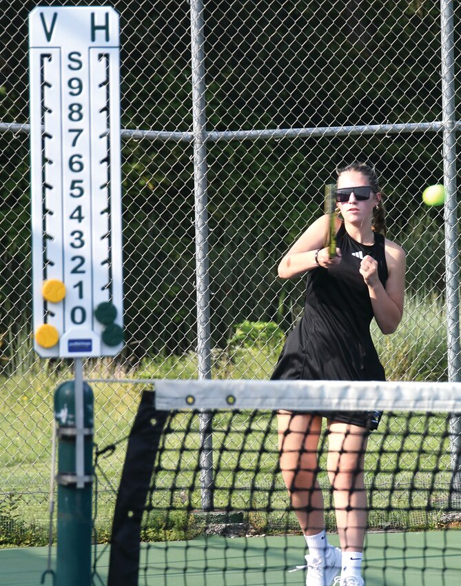 Hillsboro's Jesse Balla returns a shot during her match with Ellie Schaufelberger of Greenville on Tuesday, Aug. 29, at the Hillsboro Sports Complex. The team has been putting in work on the court in both the tennis sense and in sprucing up the courts, with new score boards, court numbers, a repainted backboard and shade sails among the improvements.