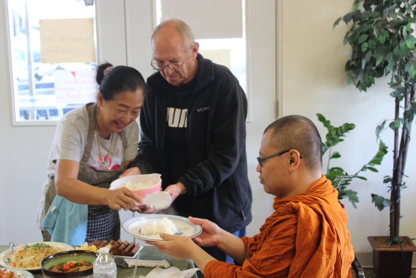 Pictured above, Bernie and Koonvadee Huber serve a monk after he blessed their food and restaurant in the Thai tradition. The Hubers celebrated the end of their inaugural season operating Happez.