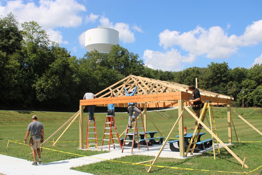 Hillsboro High School Building Trades students are hard at work constructing a new pavilion in Central Park. Pictured above, class instructor Aaron Shultz helps students Alec Leetham, Elias Guiterrez, Jace Stewart and Elliot Lentz  put in one of the many repurposed trusses.
