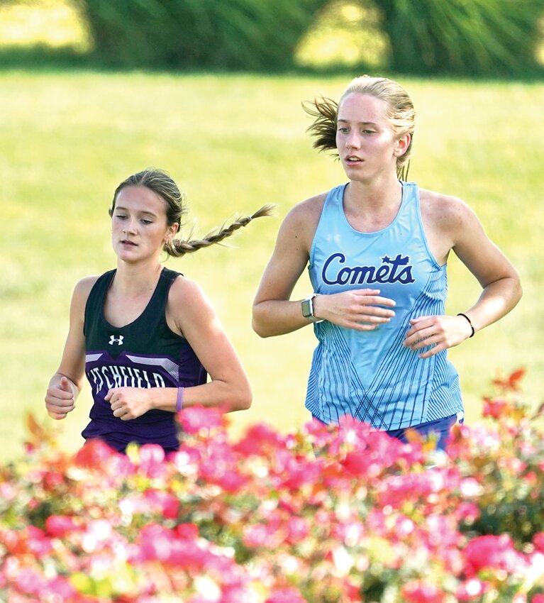 Greenville was in full bloom for Litchfield's Caitlyn Travis (left) and Greenville's Katrina Campbell as the two competed in the Dave Holden Open on Tuesday, Sept. 12. Campbell finished second in the race that honors the late founder of the Greenville cross country program, but Travis and the Panthers took the top team spot, with six runners finishing in the top eight.