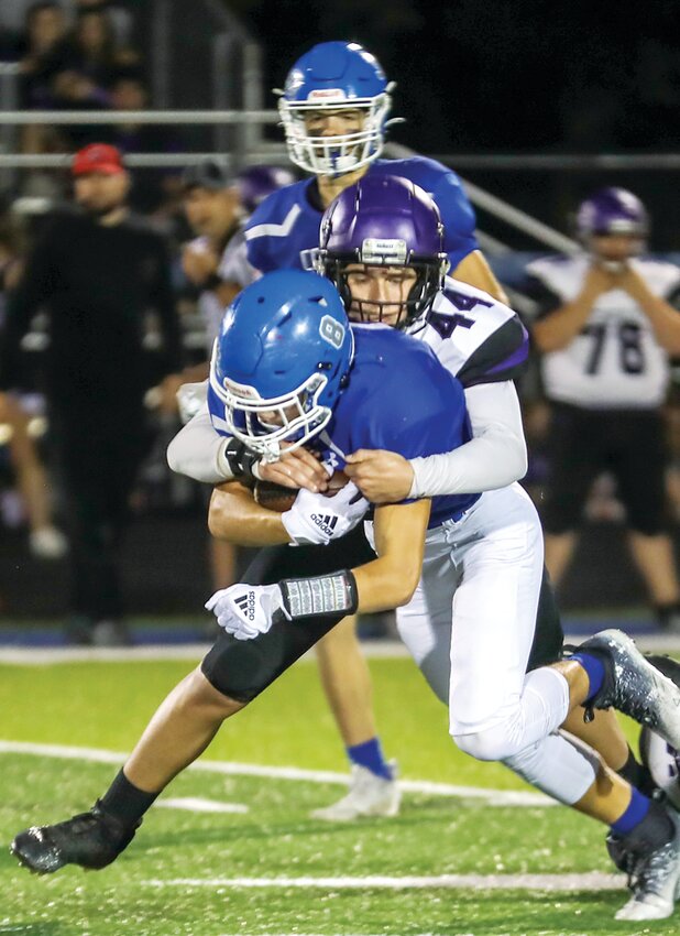 Litchfield's Max Leitschuh works to haul down Greenville running back Carson Bearley during the Panthers' week four match-up with the Comets on Sept. 15. Litchfield put a scare into the undefeated Comets, trailing just 28-20 going into the fourth quarter, before Greenville held on for a 34-20 victory.