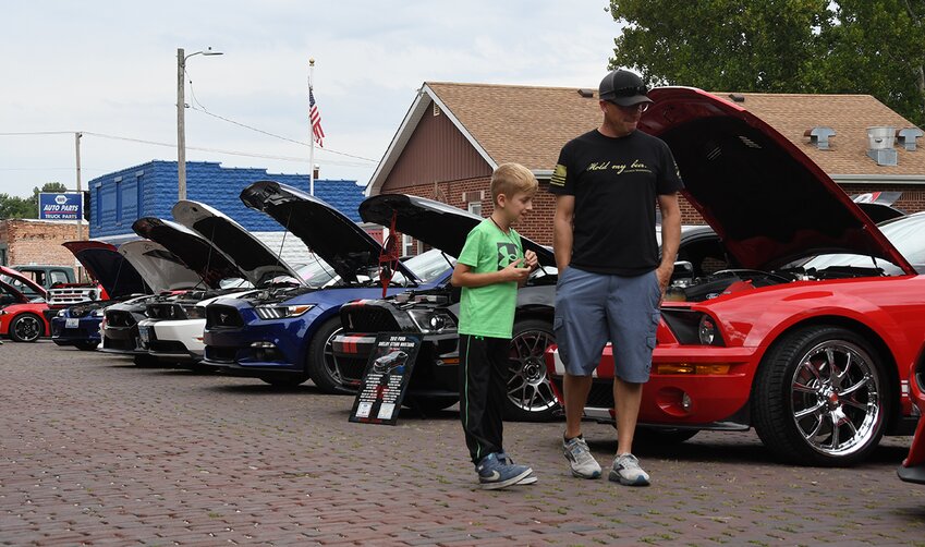 Brian Cress of Fillmore and his ten-year-old son, Kale, enjoy checking out some of the 55 cars on display at the inaugural Canines and Cars event, held Saturday, Sept. 16, at Fred B. Johnson Park in Nokomis.